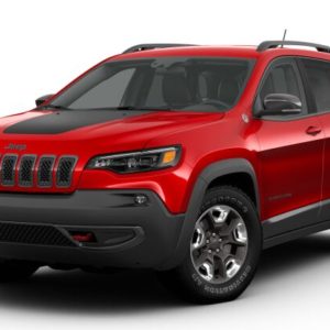 A red jeep cherokee is parked on the street.