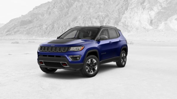A blue jeep compass parked in the snow.