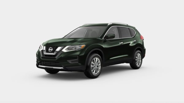 A green nissan rogue is parked on the street.
