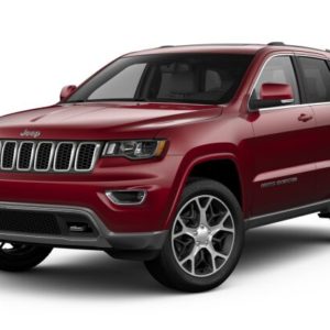 A red jeep grand cherokee is parked in front of the camera.